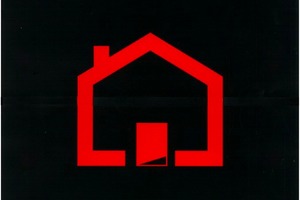 Obraz domu w czerwonym kolorze na ciemnym tle. (photo)