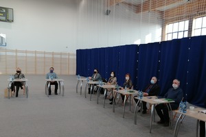 Sesja Rady Gminy , która odbyła się na Hali Widowiskowo-Sportowej w Miejskiej Górce. Na zdjęciu znajduje się kilku radnych siedzących w ławkach. (photo)