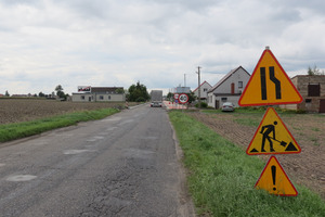 Droga prowadząca do miejscowości. Na pierwszym planie znajdują się trzy żółte znaki (photo)
